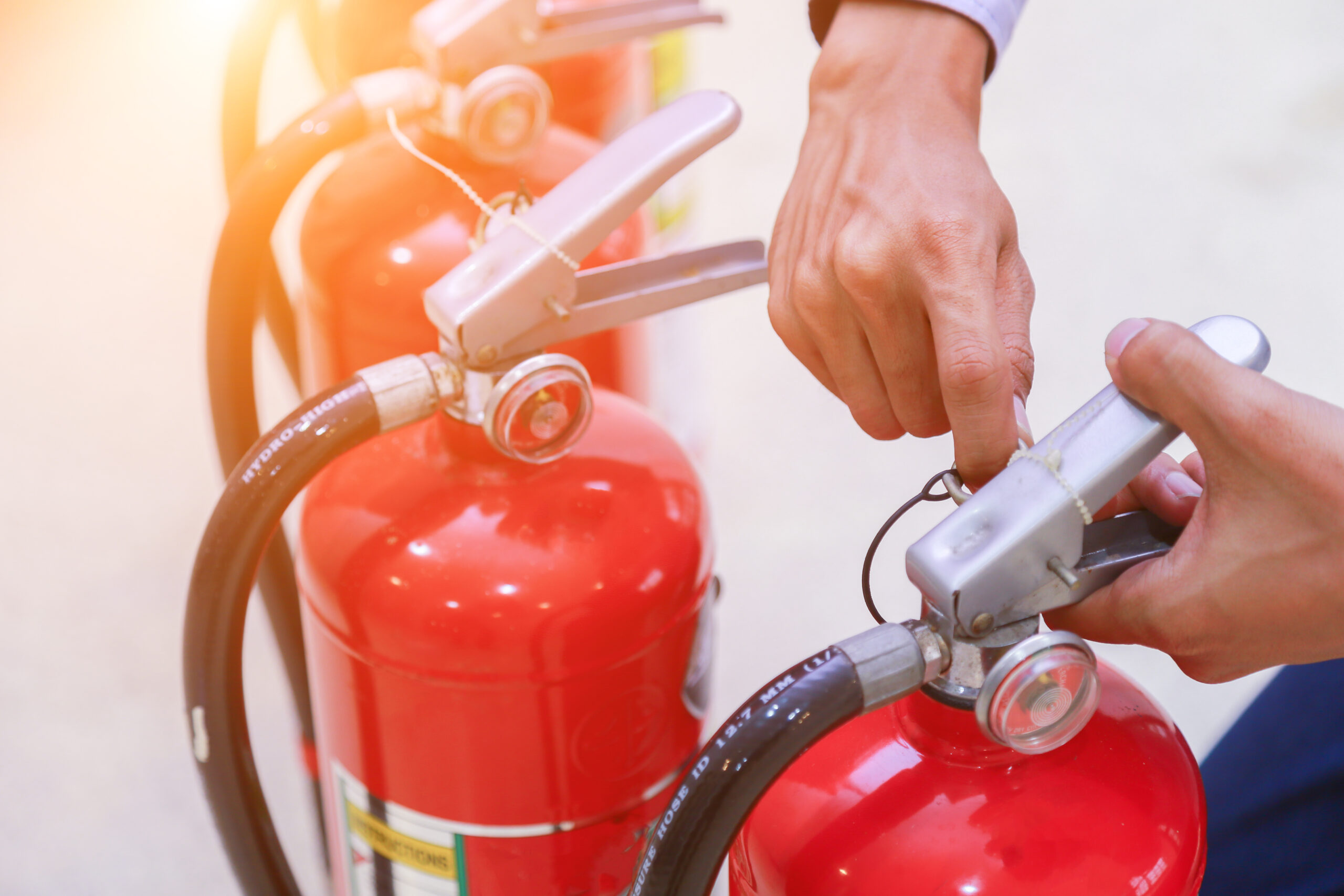The image displays portable fire extinguishers.
