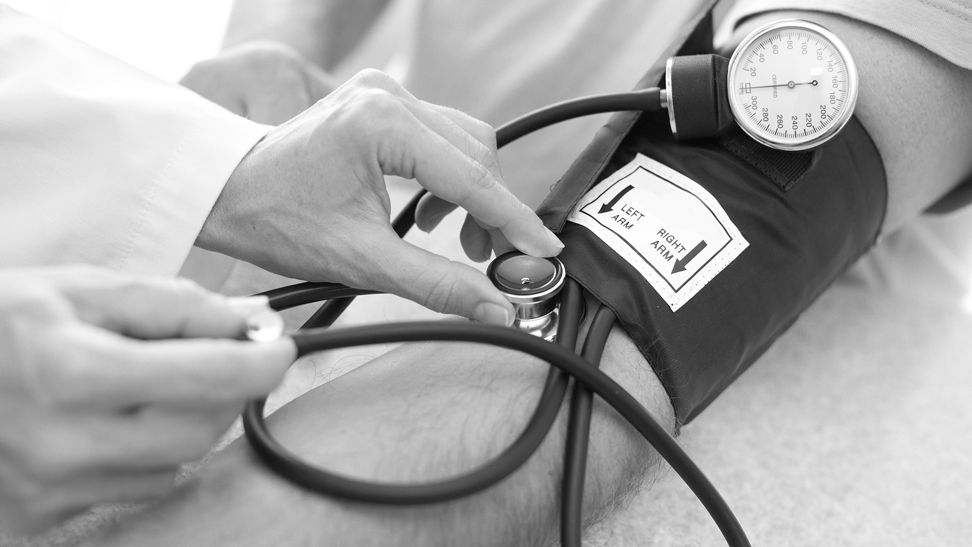 a medical professional conducting a blood pressure measurement on a patient