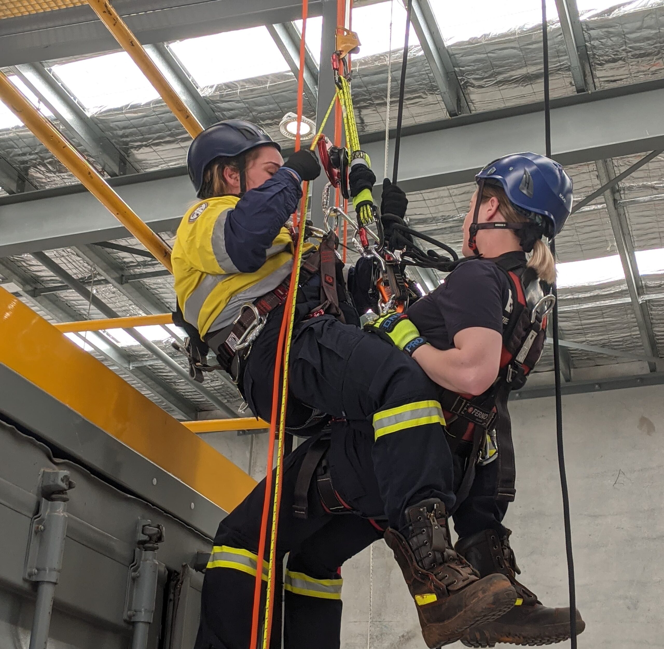 Two women performing vertical rescue.
